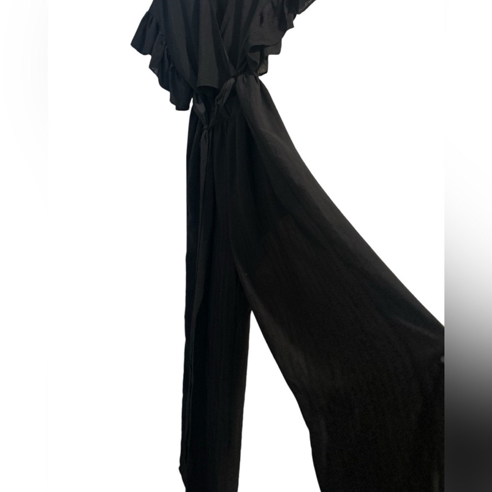 Women’s Black Romper in a size Large. V-neck front with a tie front